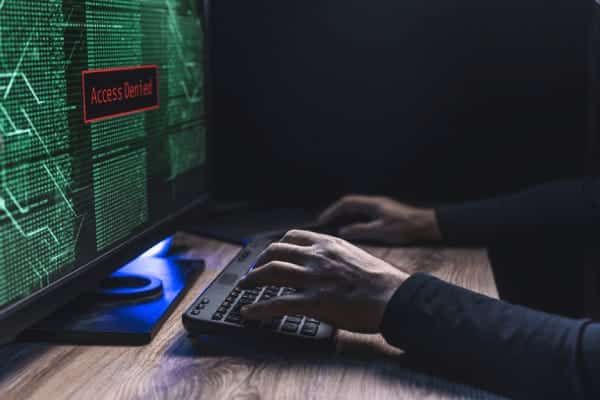 A person attempts to hack the security system and receives an “Access Denied” message