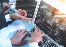 Two persons working on network device management