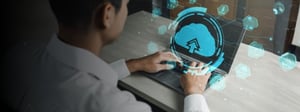 Person working on a laptop with a digital cloud upload icon and interface overlay, representing cloud-based storage and enterprise cloud services.