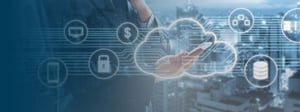 Business professional holding a smartphone with a digital cloud interface overlay, illustrating cloud computing, data storage, security, and connected business services.